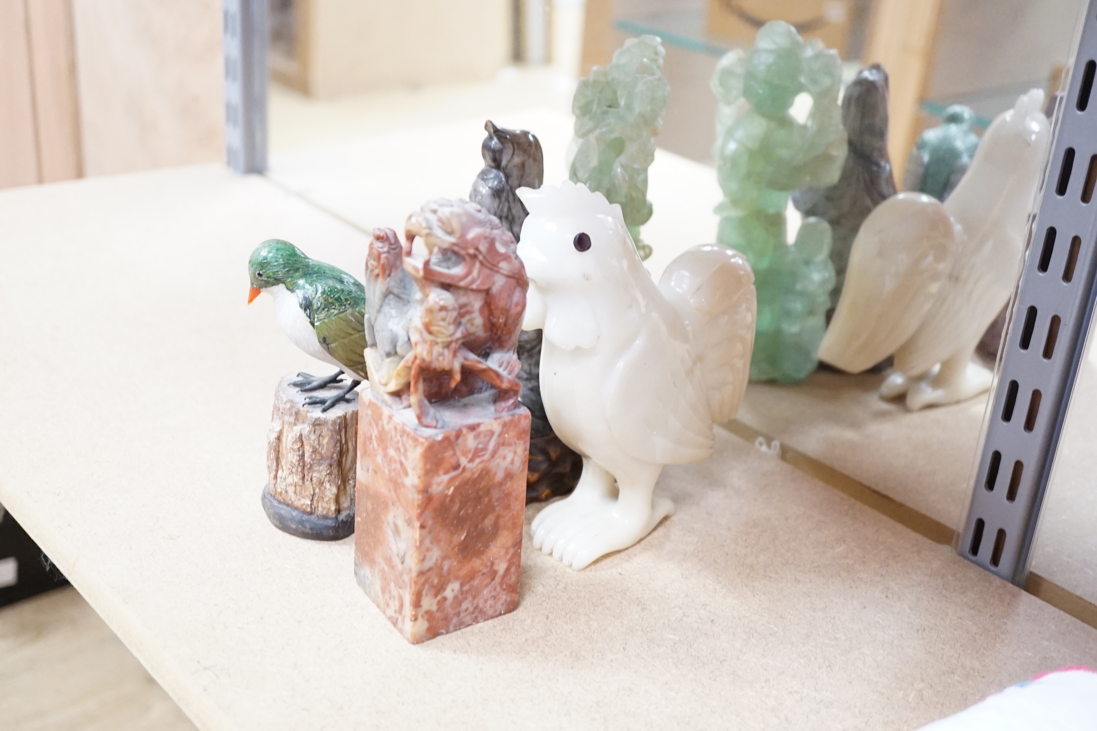 A collection of assorted Chinese hardstone carvings, boxes etc, including a Chinese jadeite carving of a lady, 7.8cm high, wood stand